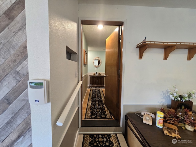 interior space with a textured ceiling and tile patterned flooring