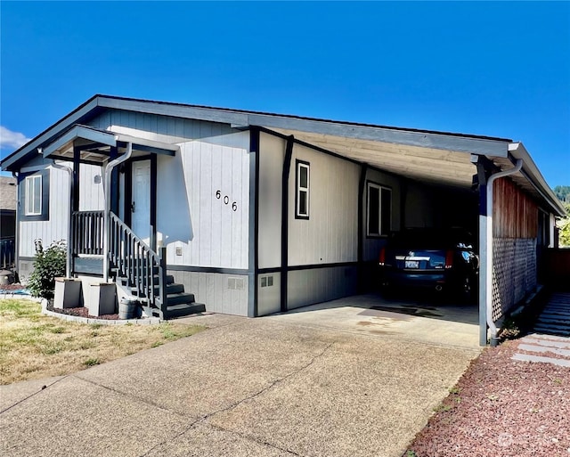 view of home's exterior with an attached carport and concrete driveway