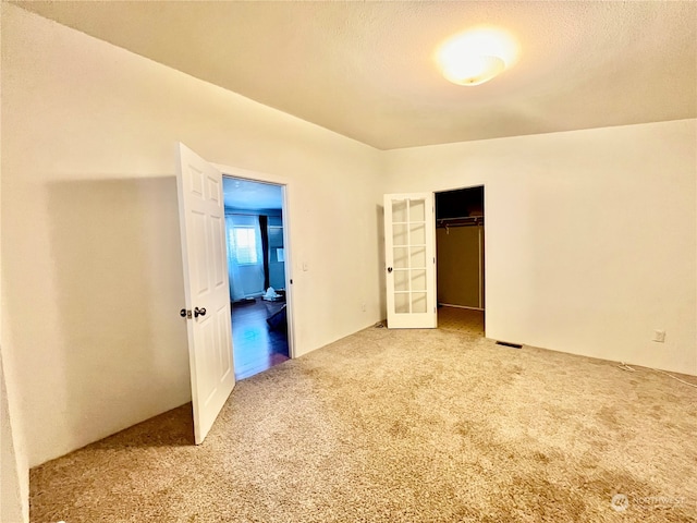 unfurnished bedroom featuring a closet and light carpet