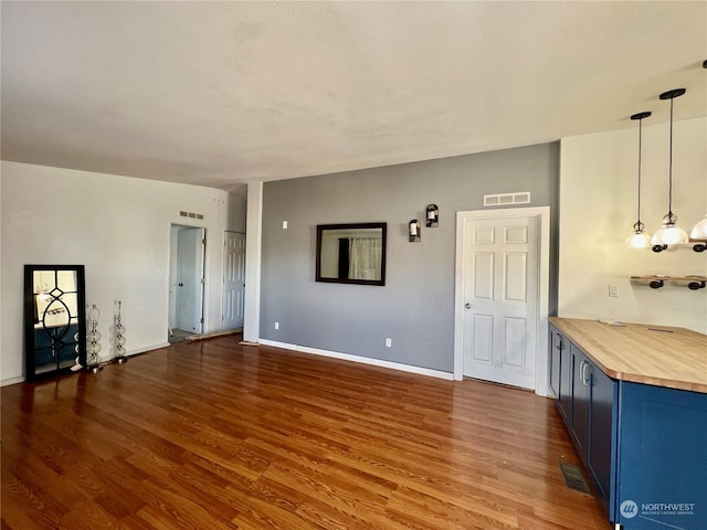 unfurnished living room featuring wood-type flooring