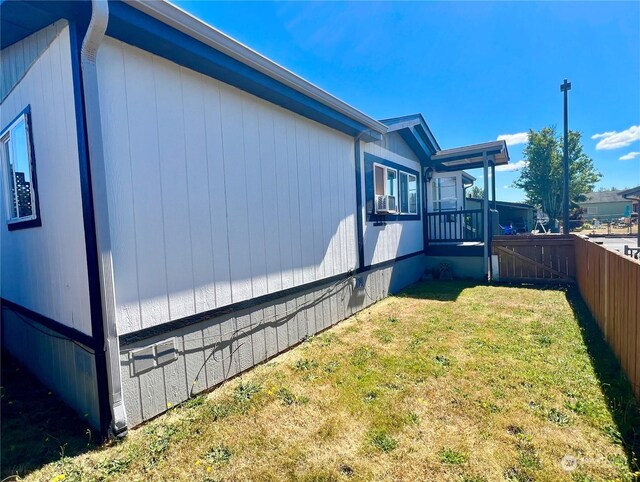 view of side of home with a lawn