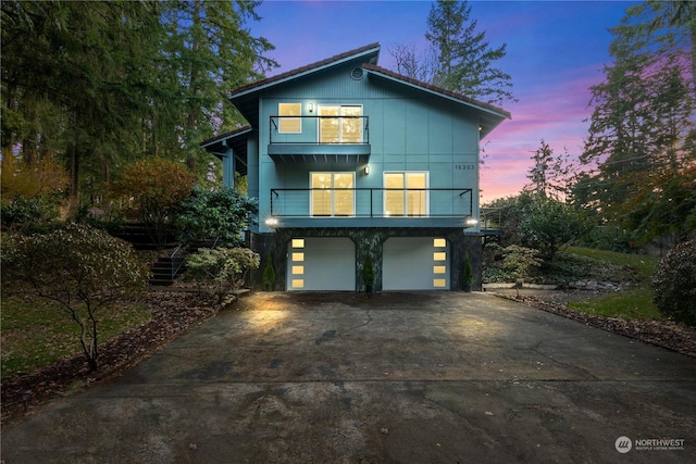 view of front of home featuring a balcony and a garage