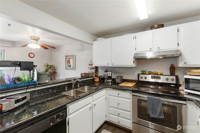 kitchen with dark stone counters, white cabinets, ceiling fan, appliances with stainless steel finishes, and sink