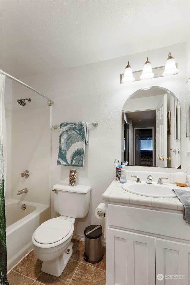 full bathroom featuring vanity, shower / tub combo, tile patterned flooring, and toilet