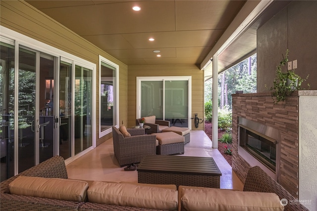 view of patio / terrace with an outdoor living space with a fireplace