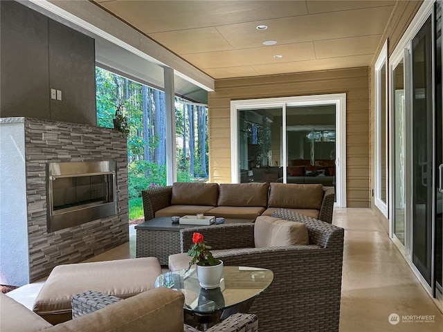 living room with an outdoor stone fireplace