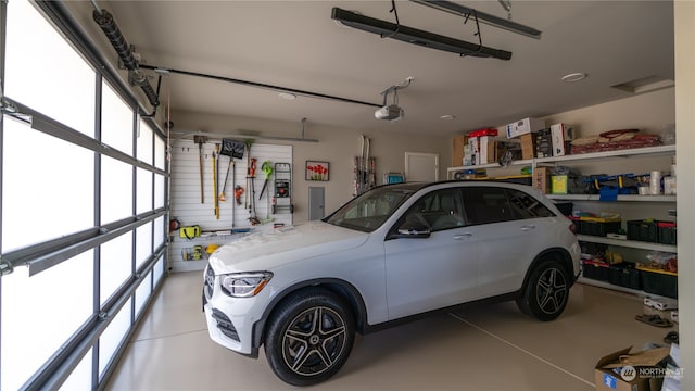 garage featuring electric panel and a garage door opener