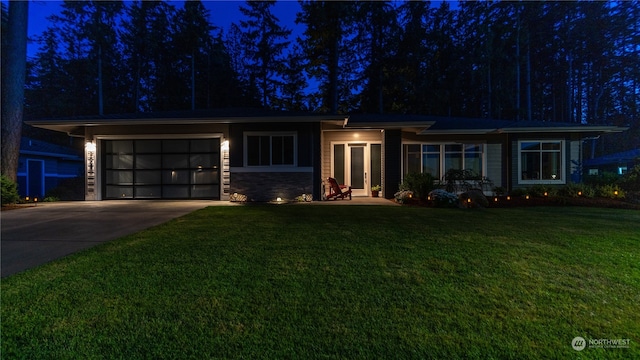 view of front of house with a garage and a lawn