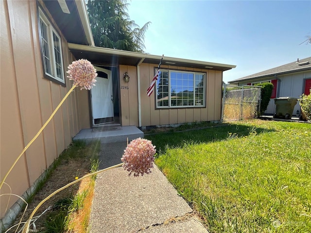 entrance to property featuring a yard