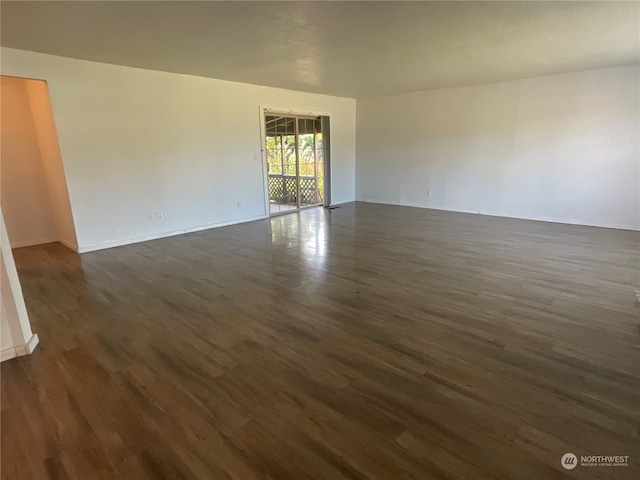 unfurnished room with dark hardwood / wood-style floors