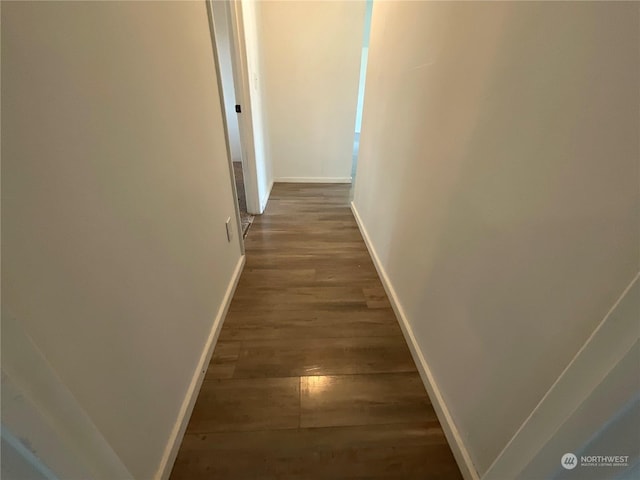 hallway with dark hardwood / wood-style flooring