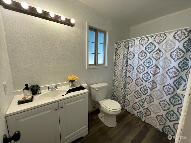 bathroom featuring hardwood / wood-style flooring, vanity, and toilet