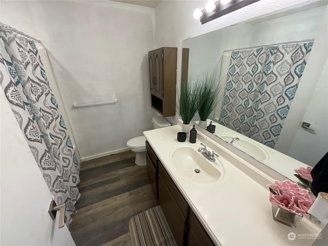 bathroom featuring vanity, toilet, and hardwood / wood-style floors