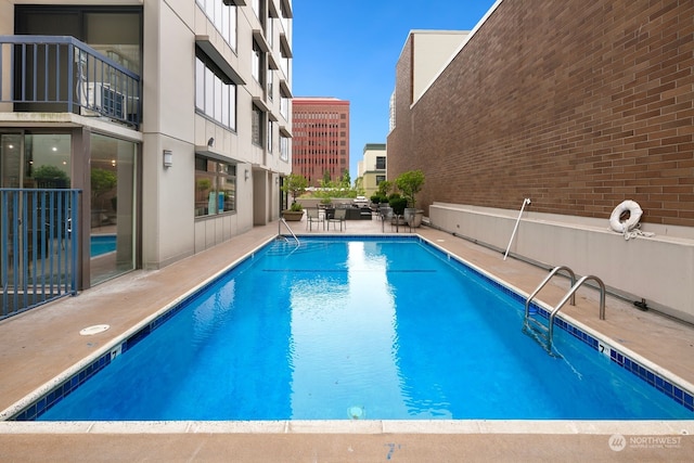 view of swimming pool featuring a patio area