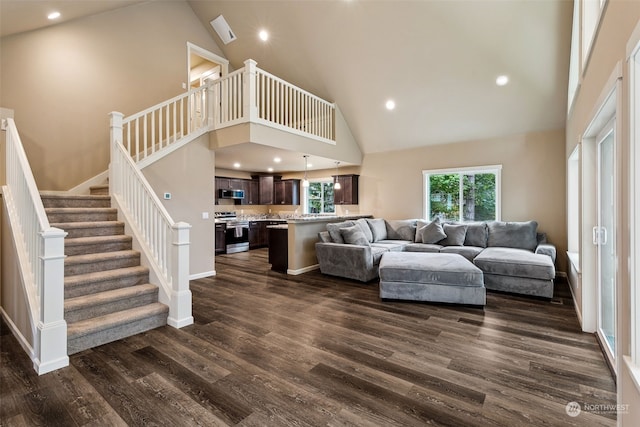 living area featuring high vaulted ceiling, stairs, dark wood finished floors, baseboards, and recessed lighting
