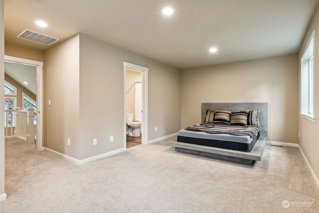 carpeted bedroom featuring connected bathroom