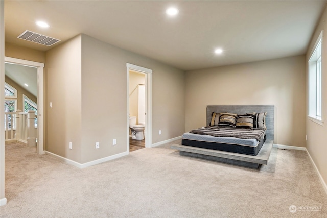 carpeted bedroom featuring recessed lighting, visible vents, baseboards, and connected bathroom