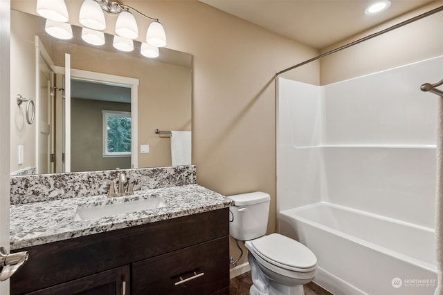 bathroom with toilet, baseboards, wood finished floors, vanity, and shower / tub combination