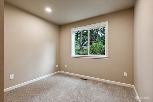 empty room with recessed lighting, baseboards, visible vents, and carpet