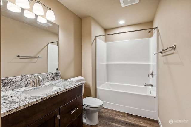 full bathroom with shower / washtub combination, toilet, vanity, and wood-type flooring