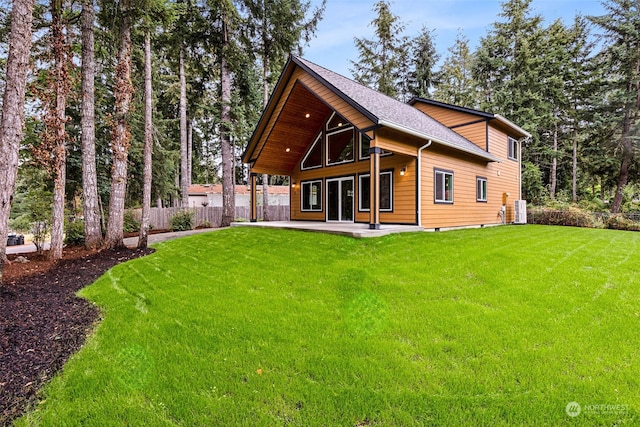 back of house featuring a yard and cooling unit