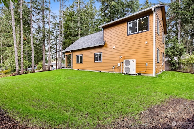 rear view of house featuring a lawn