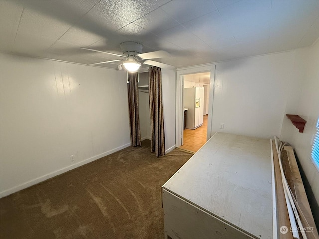 spare room featuring carpet floors and ceiling fan