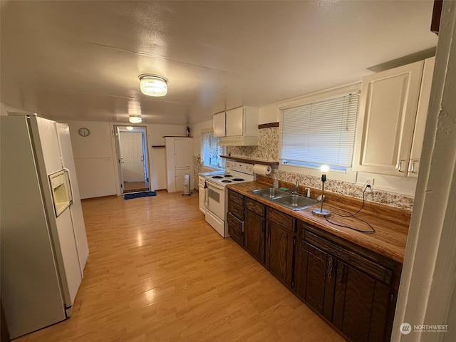 kitchen featuring sink, light wood-type flooring, white cabinets, dark brown cabinets, and white appliances