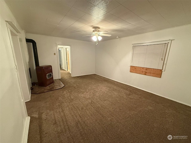 interior space featuring a wood stove and ceiling fan