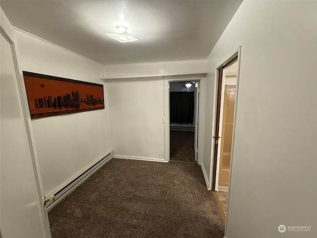 hallway with a baseboard radiator and dark carpet