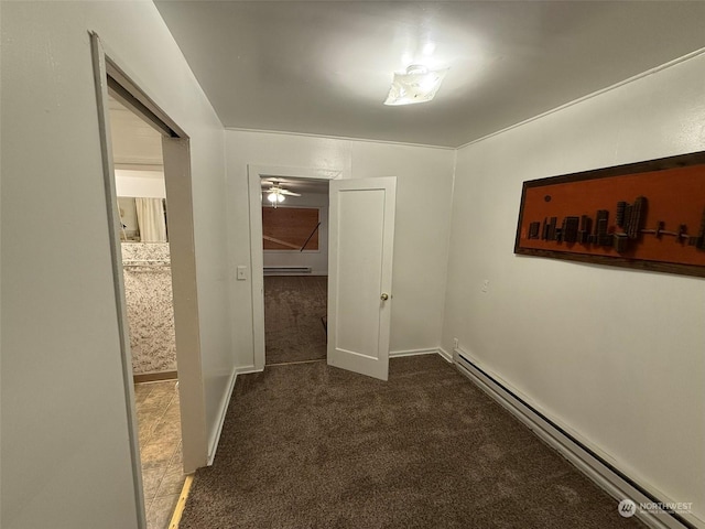 hallway with a baseboard radiator and dark carpet