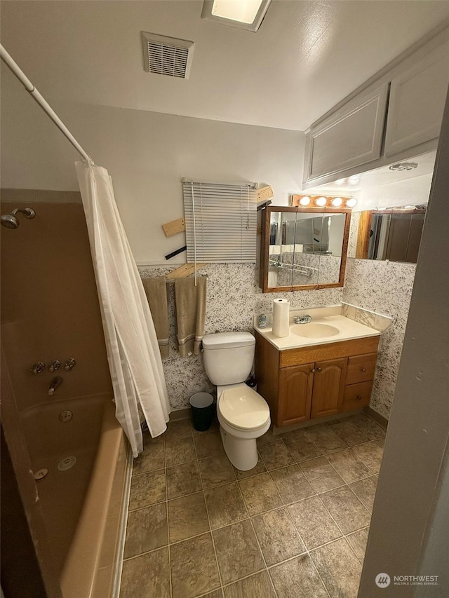 full bathroom with shower / tub combo, vanity, and toilet