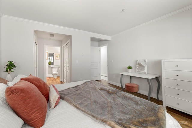 bedroom with ornamental molding, connected bathroom, and hardwood / wood-style floors