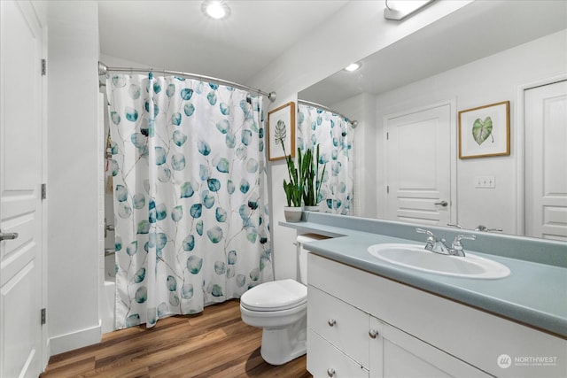 full bathroom featuring vanity, wood-type flooring, shower / tub combo, and toilet