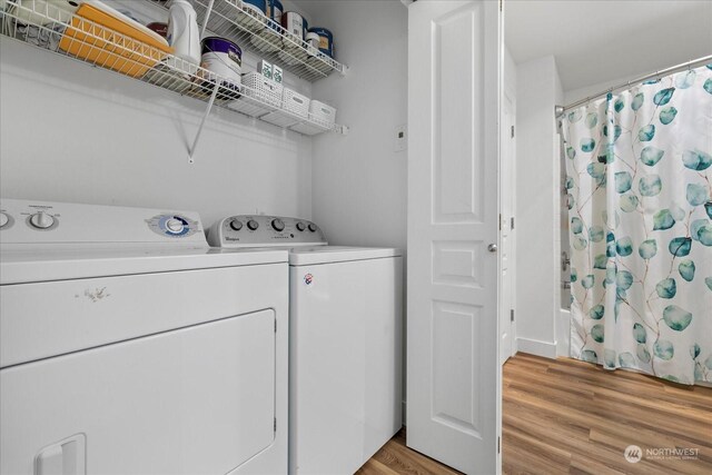 laundry room with light hardwood / wood-style flooring and independent washer and dryer