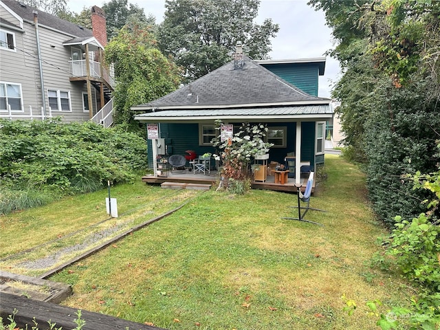 rear view of house with a yard