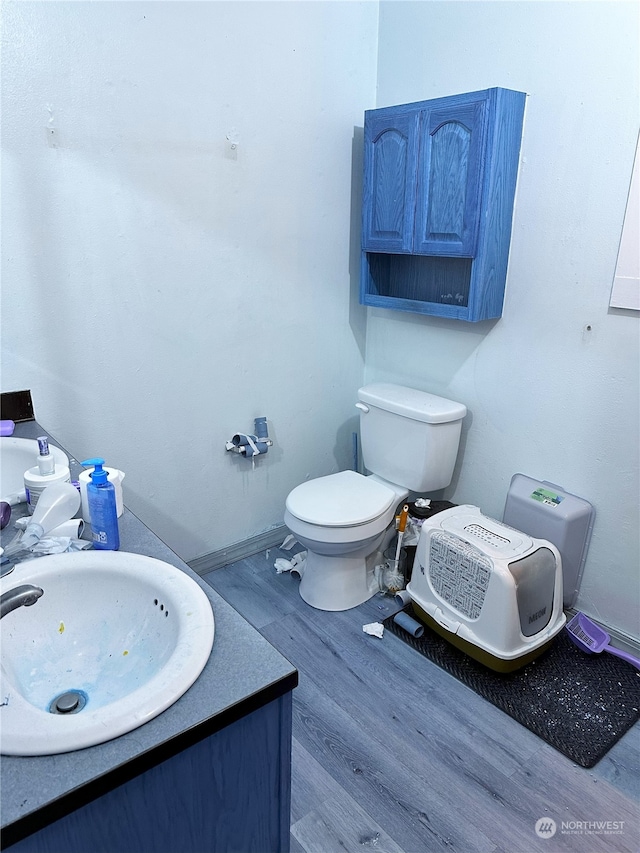 bathroom featuring vanity, hardwood / wood-style flooring, and toilet