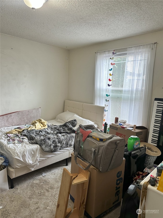 carpeted bedroom with a textured ceiling