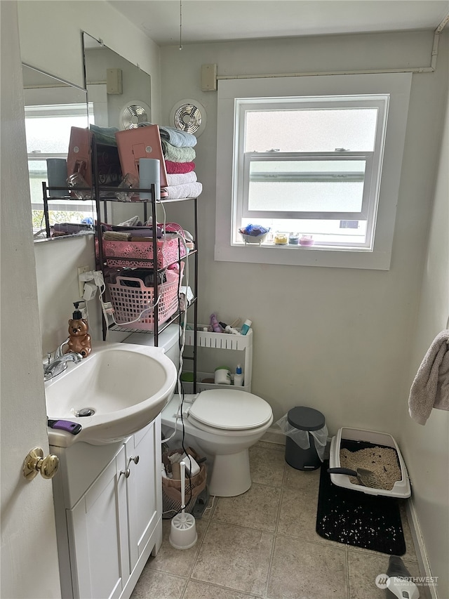 bathroom featuring tile patterned floors, toilet, and vanity