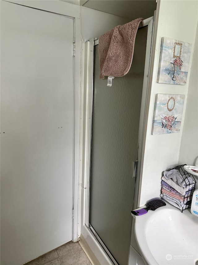 bathroom featuring tile patterned flooring and a shower with door