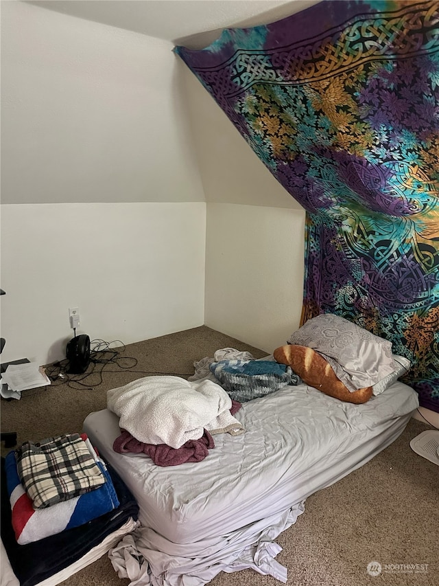 bedroom featuring vaulted ceiling and carpet flooring