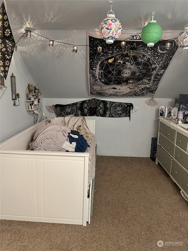 bedroom featuring lofted ceiling and carpet flooring