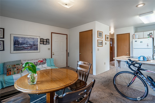 dining space with light colored carpet