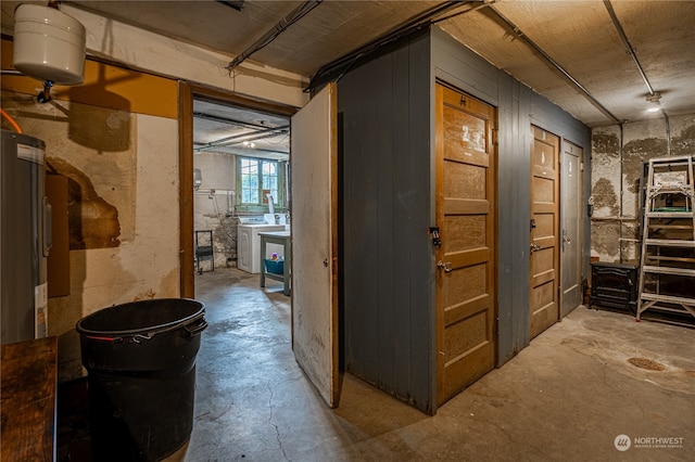 hallway with washer / clothes dryer and concrete flooring