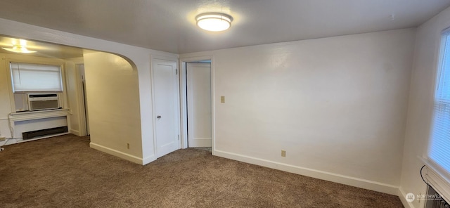 unfurnished bedroom featuring a closet, cooling unit, and carpet floors