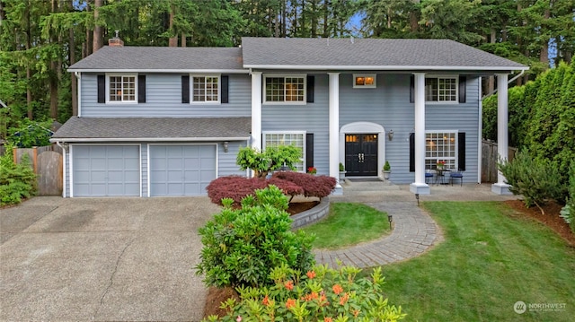 view of front of home featuring a garage and a front yard