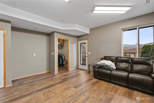 living room featuring hardwood / wood-style flooring and a mountain view