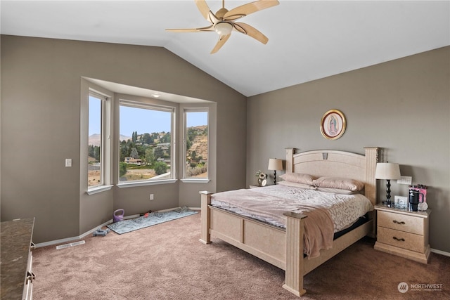 bedroom with vaulted ceiling, ceiling fan, and dark carpet