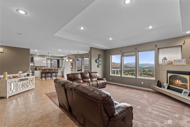 tiled living room with a fireplace and a mountain view