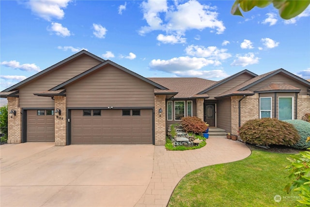 view of front of house featuring a garage and a front lawn